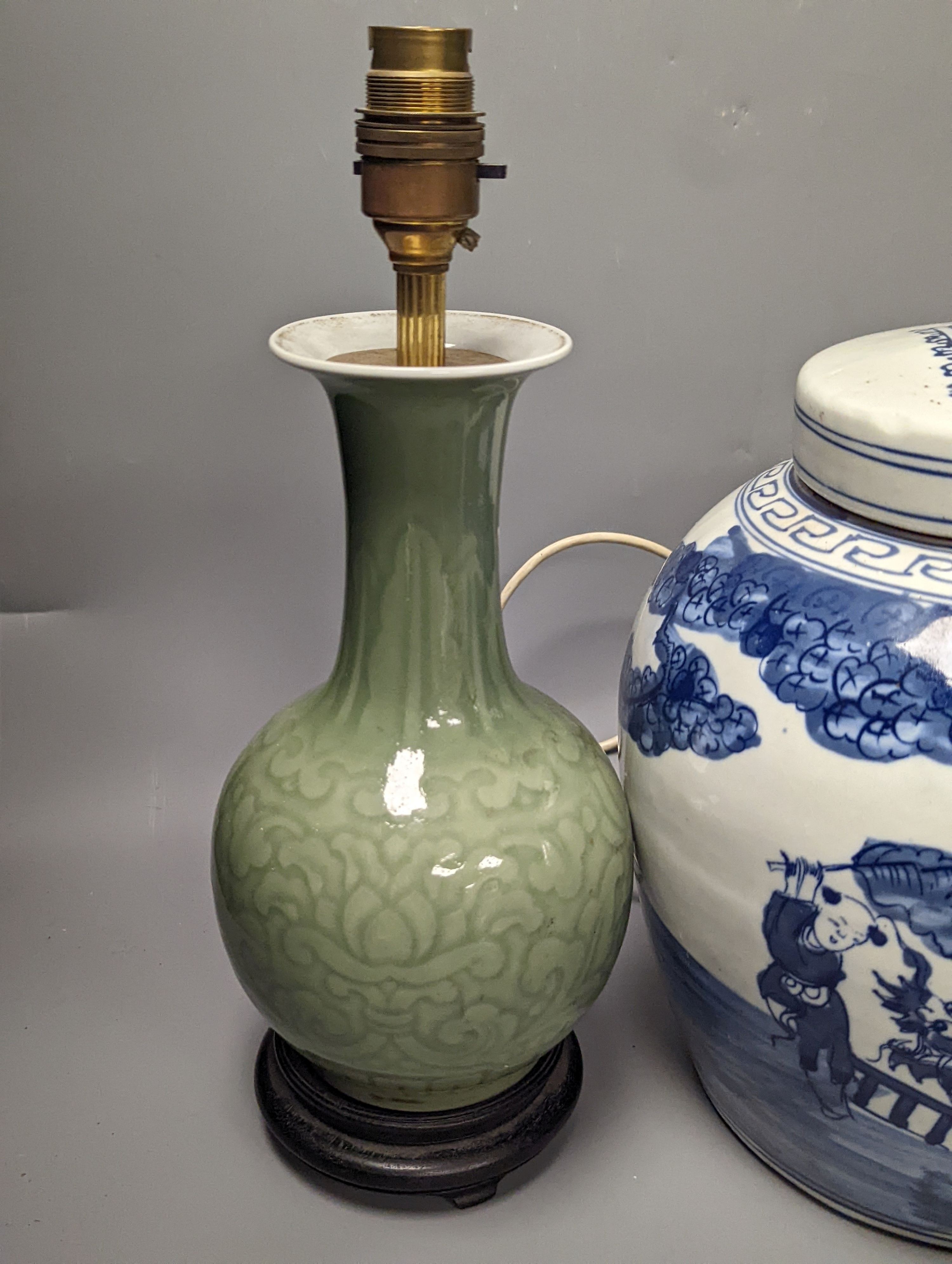 A Chinese blue and white jar and cover, 25 cm high and a celadon glazed lamp